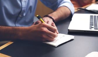 office worker or recruiter making notes to help meet recruitment targets